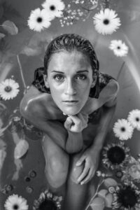 This photograph came up in a search on the keyword "vulnerable." A woman crouching in a bathtub with flowers in the water looking up at the camera with her hand under her chin. I love her earnest, open, yet clear and powerful expression: the power that comes from vulnerability.