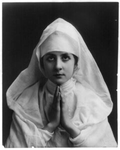 Here is how to cultivate a habit, ornamented by an image of a young woman wearing a half-length white nun's habit with her hands in prayer looking upward into the camera in this black and white image by post-Civil-War photograph Fitz W. Guerin, held by the Library of Congress, found in Wikimedia Commons. 